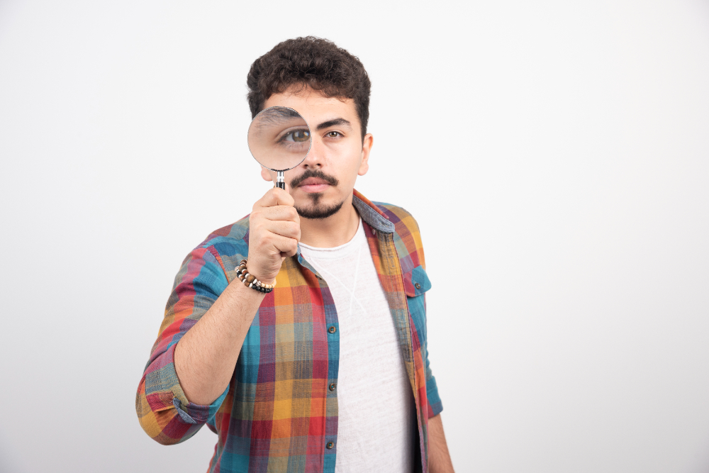 a image of job interview candidate looking into magnifying lens with one eye zoom in shot